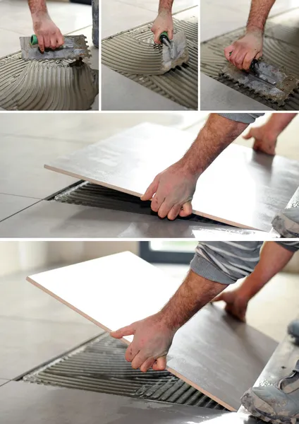 Handyman sprida lim på golvet — Stockfoto