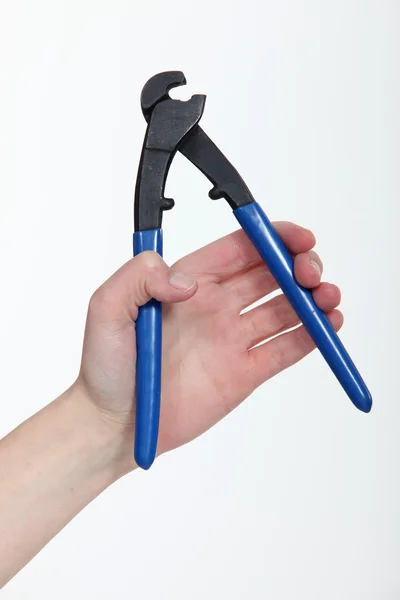 Hand holding pliers — Stock Photo, Image