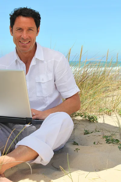 Mann arbeitet am Strand. — Stockfoto