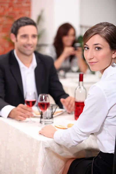 Paar in restaurant met vrouw wendde zich tot de camera — Stockfoto
