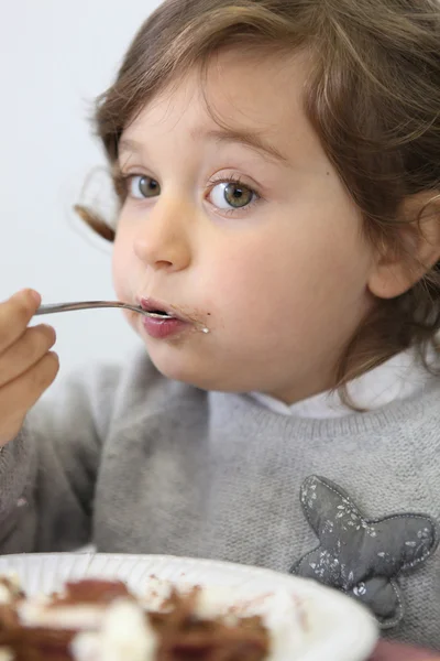Portrait of a little girl eating — Stock Photo, Image