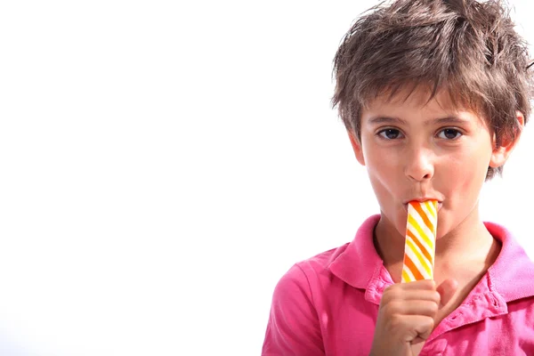 Boy sucking on a lollipop — Stock Photo, Image