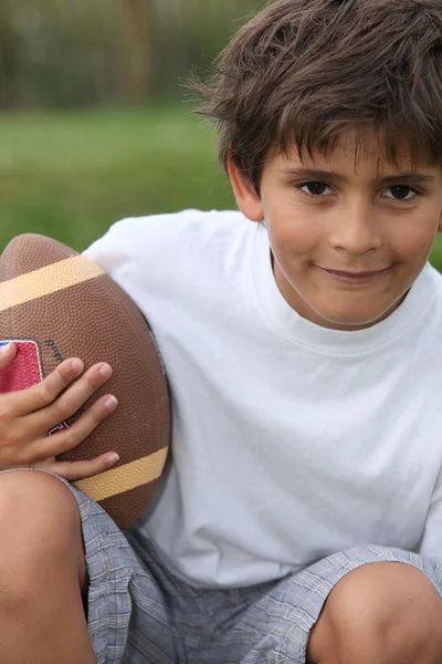 Boy playing American football — Stock Photo, Image