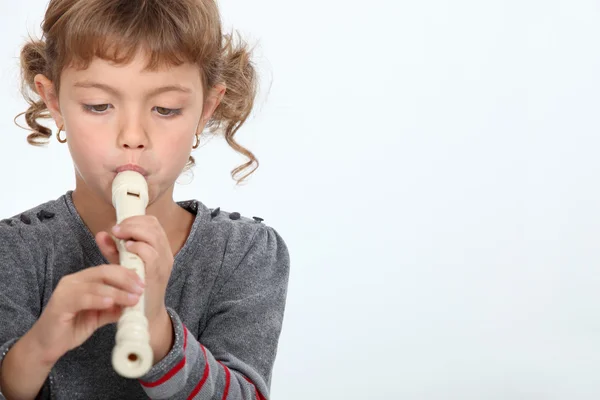 Girl playing a recorder — Stock Photo, Image