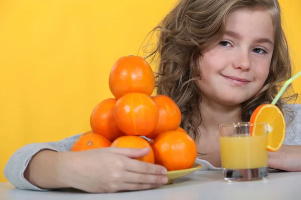 Kid drinking orange juice. — Stock Photo, Image