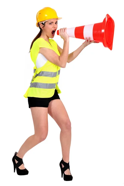 Beautiful craftswoman shouting in construction cone — Stock Photo, Image