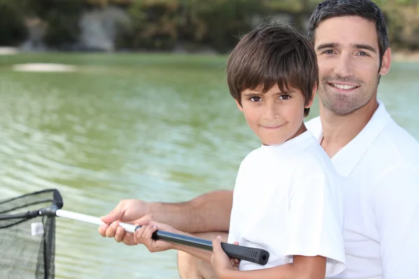 Father and son fishing on boat — Stock Photo, Image