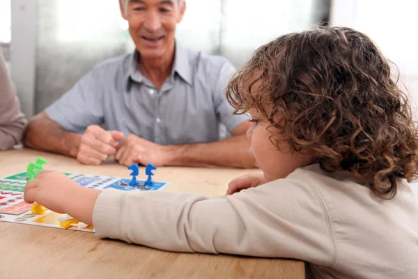 Young child playing a board game — Stock Photo, Image