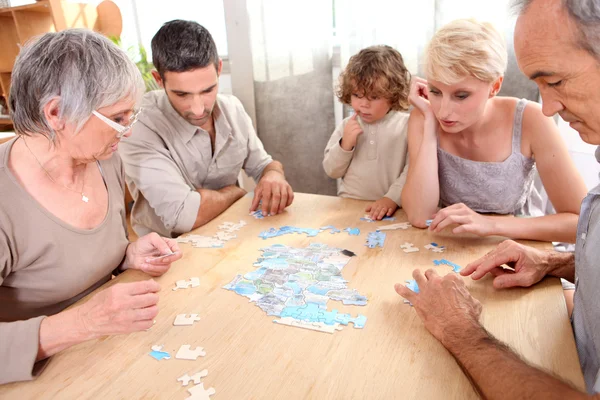 Family making puzzle — Stock Photo, Image