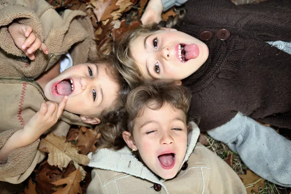 Children lying on the ground — Stock Photo, Image