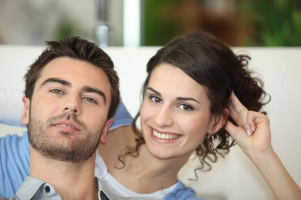 Couple sat watching television Stock Photo