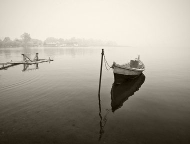 Old wooden boat in fog, black and white clipart