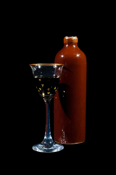 Earthenware bottle and glass with balsam — Stock Photo, Image