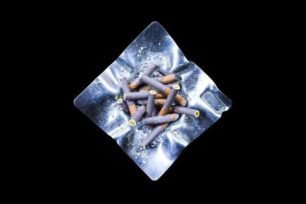 Decorated silver ashtray with cigarette butts — Stock Photo, Image