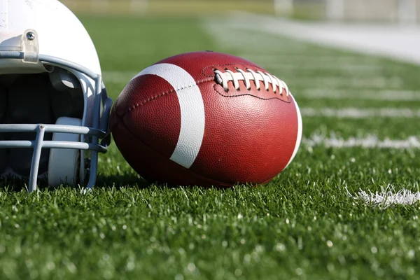 Football and Helmet on the Field — Stock Photo, Image