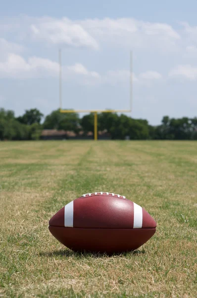 American Football with Goal Posts Beyond — Stock Photo, Image