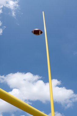 Football kicked through the Goal Posts clipart
