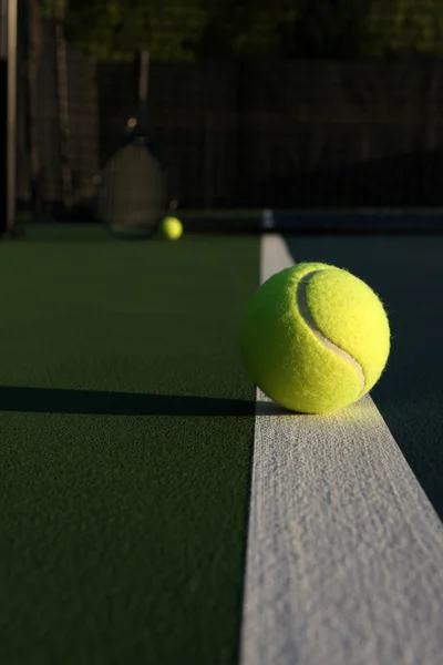 Tennis Ball with Racket in background — Zdjęcie stockowe