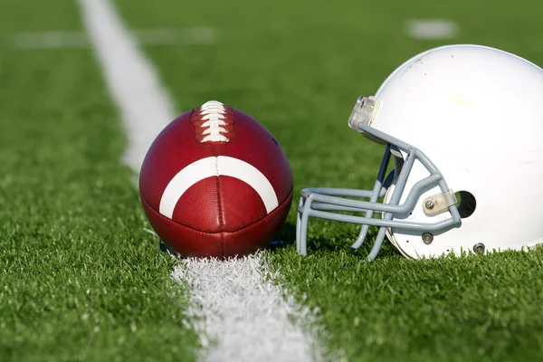 Football and Helmet on the Field — Stock Photo, Image
