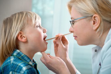 Doctor examining little child boy clipart