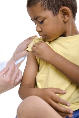 Doctor give injection to boy's arm clipart