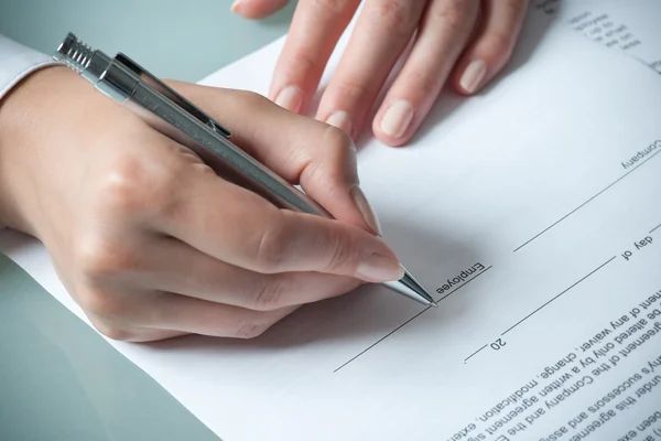 Female hands filling out employment agreement contract — Stock Photo, Image