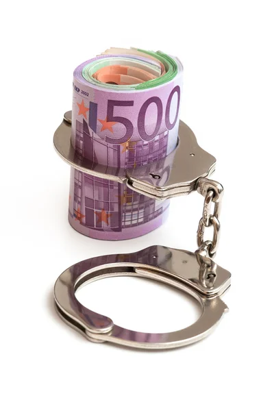 Pengar och handfängsel — Stockfoto