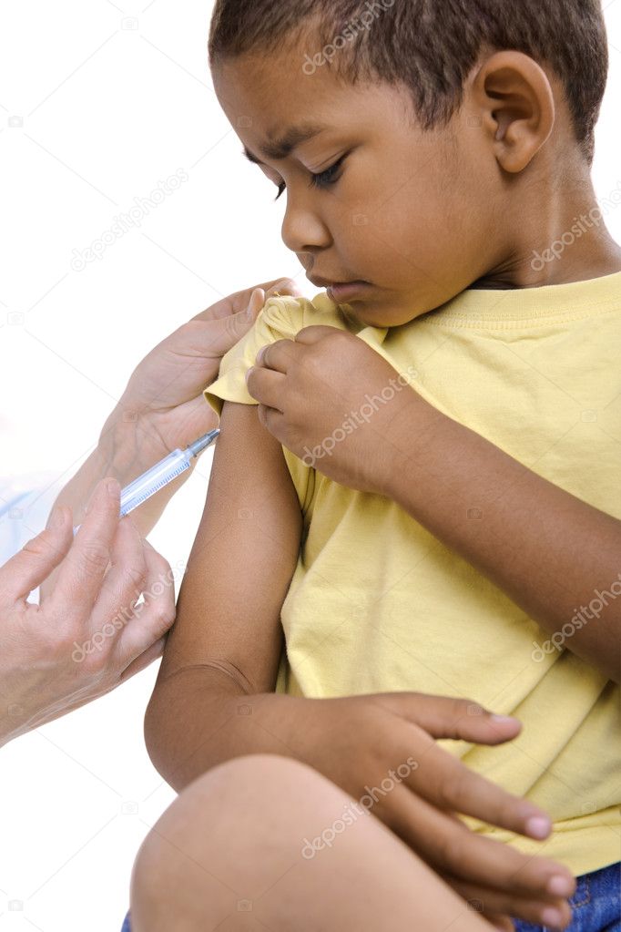 Doctor give injection to boy's arm