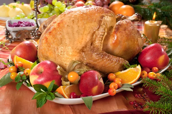 Roasted turkey on holiday decorated table — Stock Photo, Image