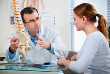 Physical Therapist with a patient clipart