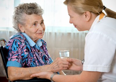 Senior woman with her home caregiver clipart