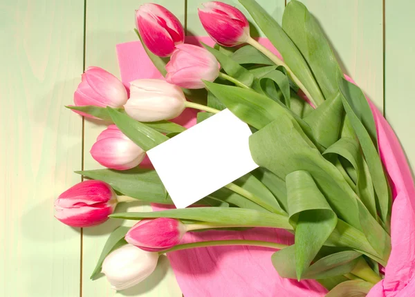 Bouquet of rose tulips with blank card — Stock Photo, Image