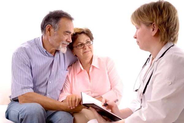 Senior couple visiting a doctor — Stock Photo, Image
