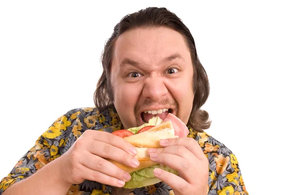 Adam bir sandviç yiyor — Stok fotoğraf
