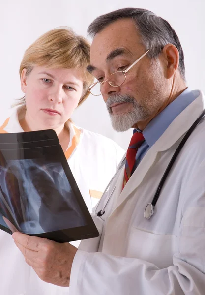 Two doctors looking at an xray — Stock Photo, Image
