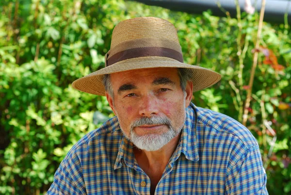 Portrait of senior man with a straw hat — Stock Photo, Image