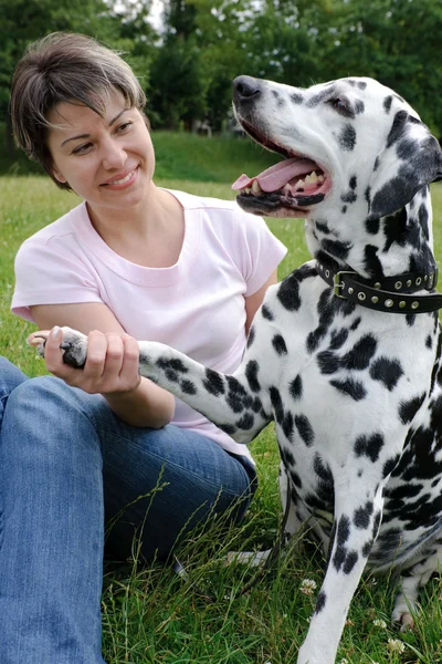 Woman playing with the dog in park — Stock Photo, Image