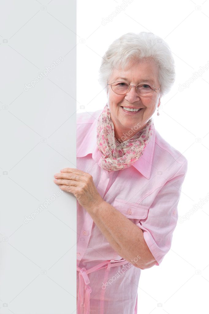 Elderly woman holding an empty white billboard