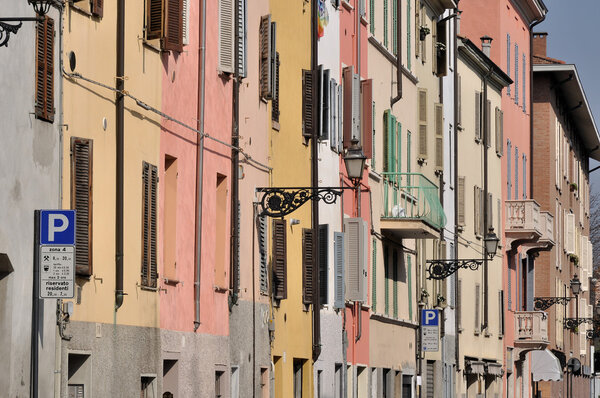 Foreshortening of windows of ancient residential buildings aligned on the street in parma citycenter