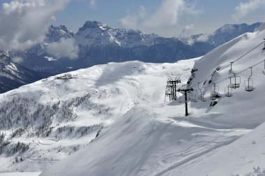 Empty chair-lift at san martino castrozza clipart