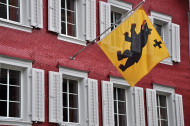 Red facade with flag, andermatt clipart