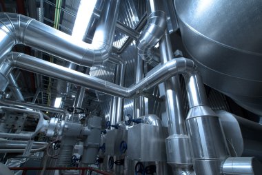 Pipes, tubes, machinery and steam turbine at a power plant clipart