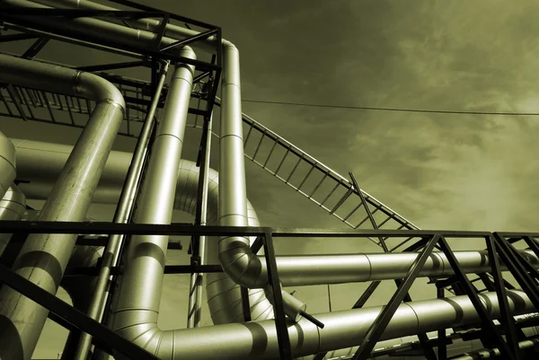 stock image Industrial pipelines on pipe-bridge against sky