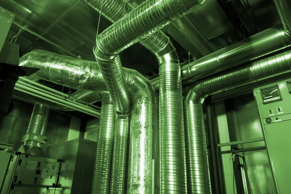 stock image Ventilation pipes of an air condition in green tones