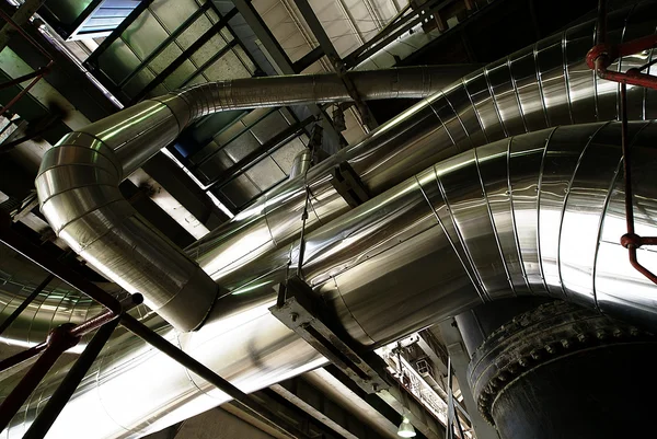 stock image Different size and shaped pipes and valves at a power plant