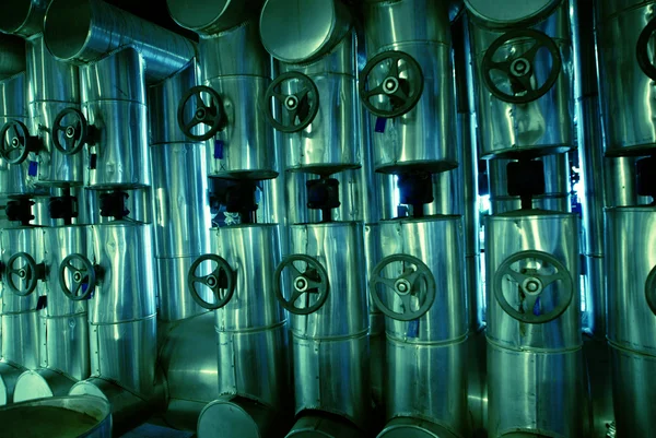 stock image Different size and shaped pipes and valves at a power plant