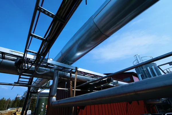 Industriegebiet, Stahlrohre und Ventile vor blauem Himmel — Stockfoto