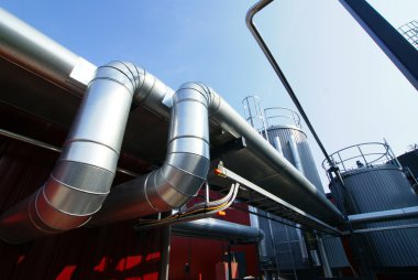 Industrial pipelines on pipe-bridge against blue sky industria clipart