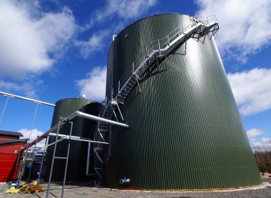 Industrial pipelines on pipe-bridge against blue sky clipart