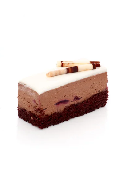 Piece of chocolate cake with white glaze — Stock Photo, Image